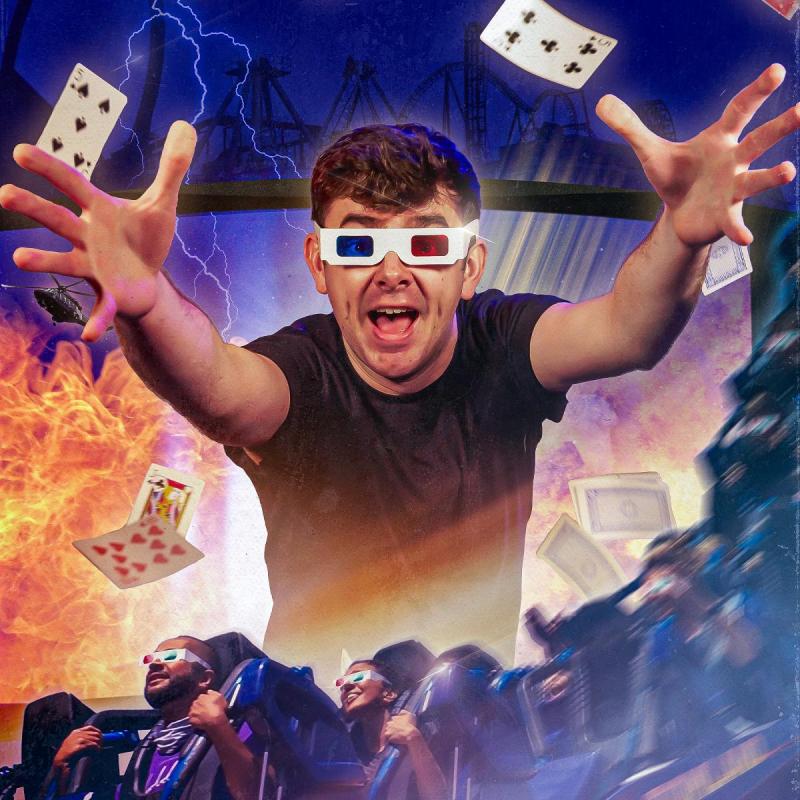 The performer wears 3D glasses and reaches his arms out. Cards are flying around in the background, and there is a rollercoaster at the bottom. 